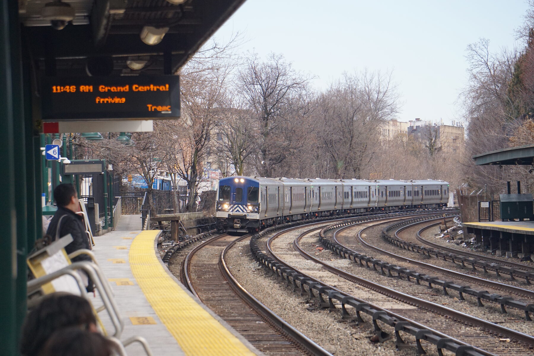 Metro-North commuter train arriving at an elevated Bronx station on a winter morning
