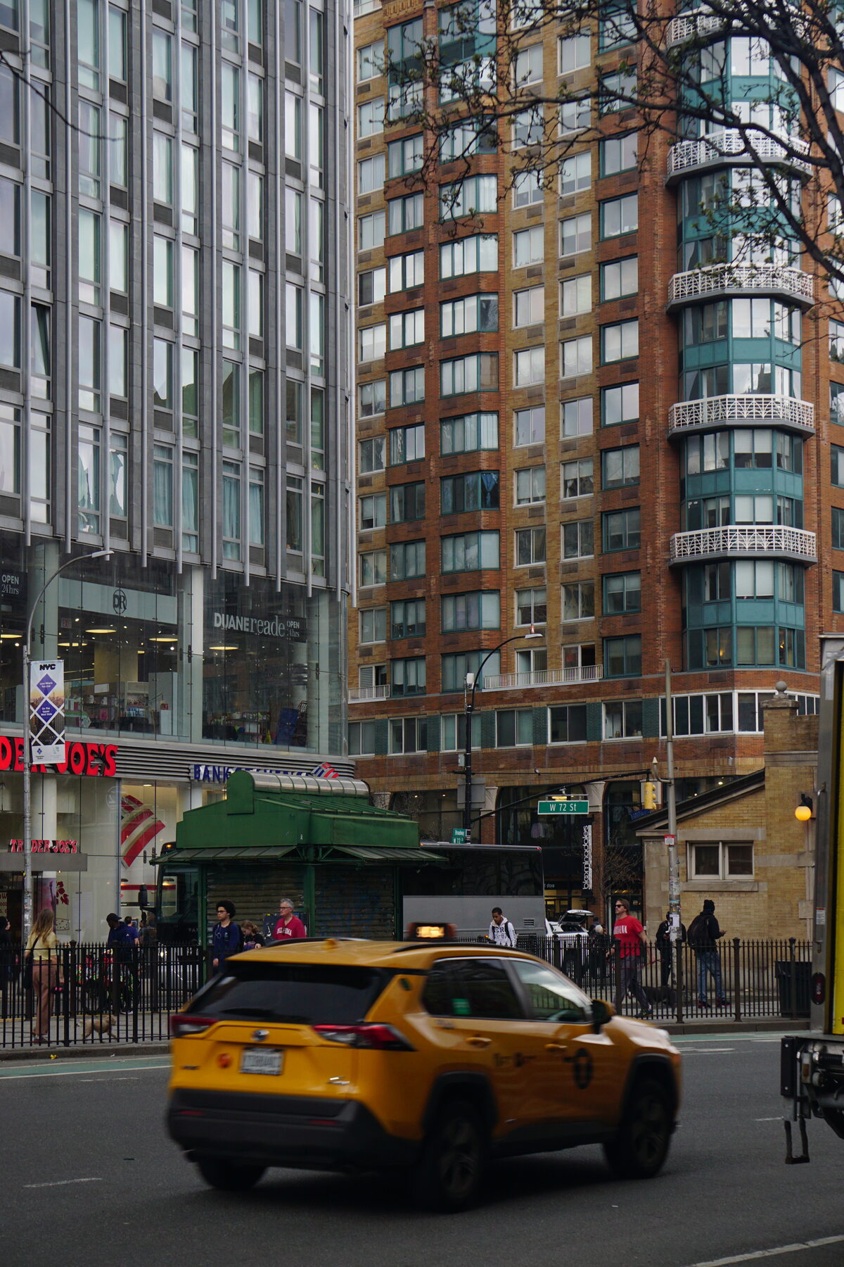 Street scene on West 72nd Street, Upper West Side, with a yellow taxi and pre-war buildings